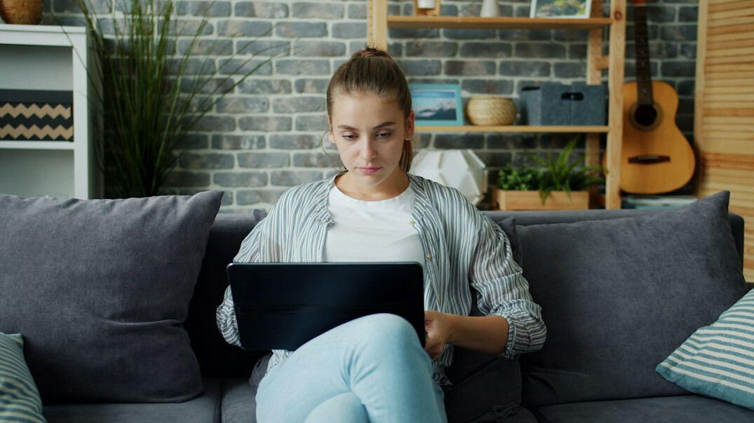 Person typing an email on a laptop at a desk